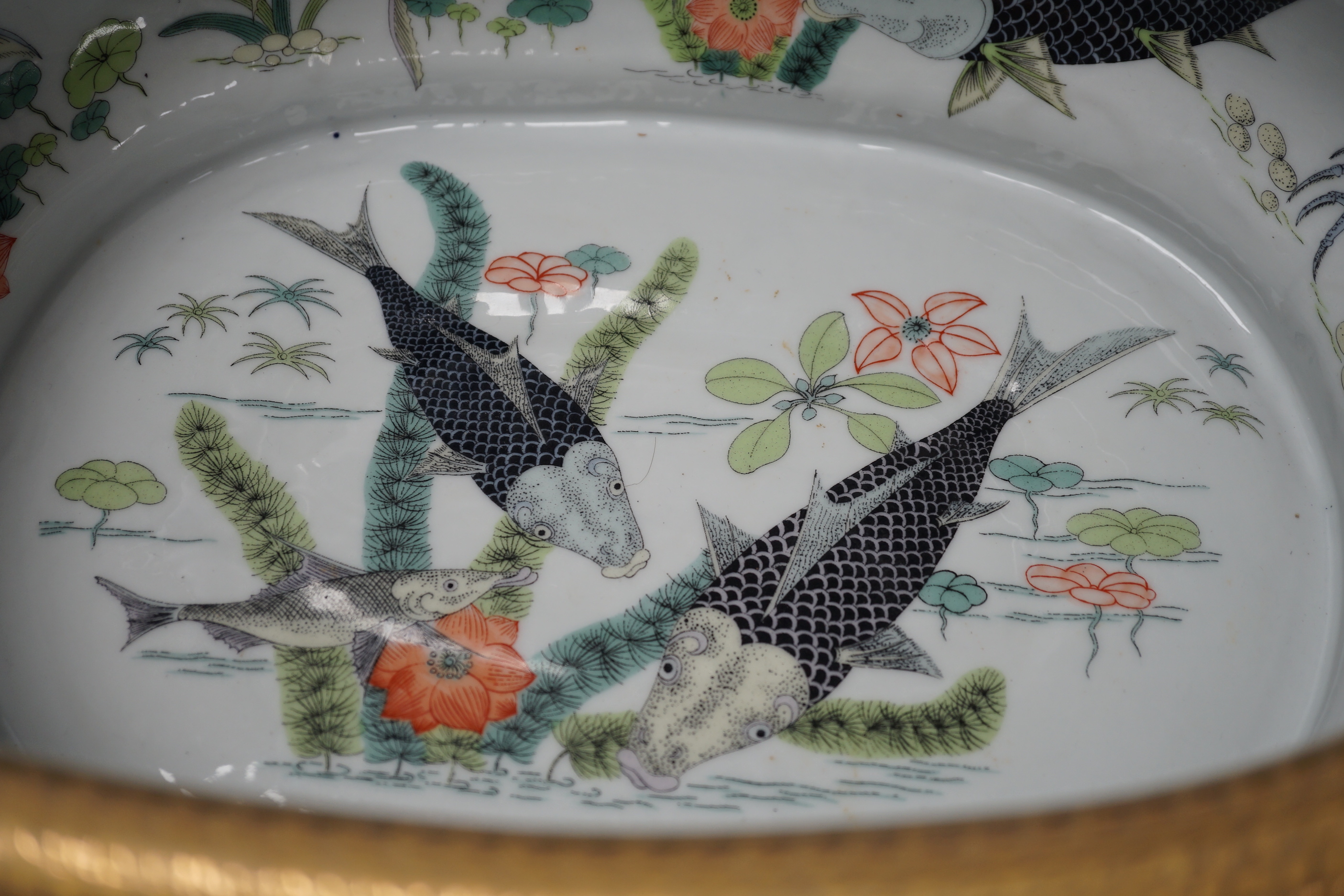 A large Chinese porcelain twin handled bowl decorated with fish and flowers, 44cm wide